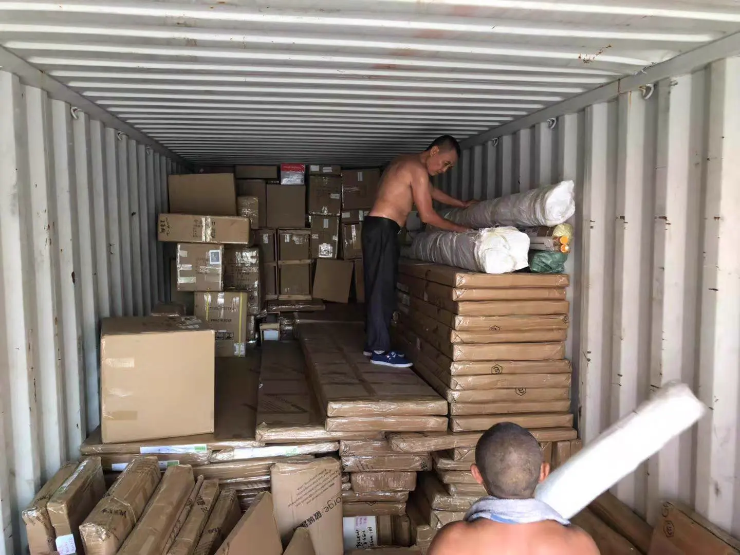 Containers being loaded with inspected tiles before dispatch